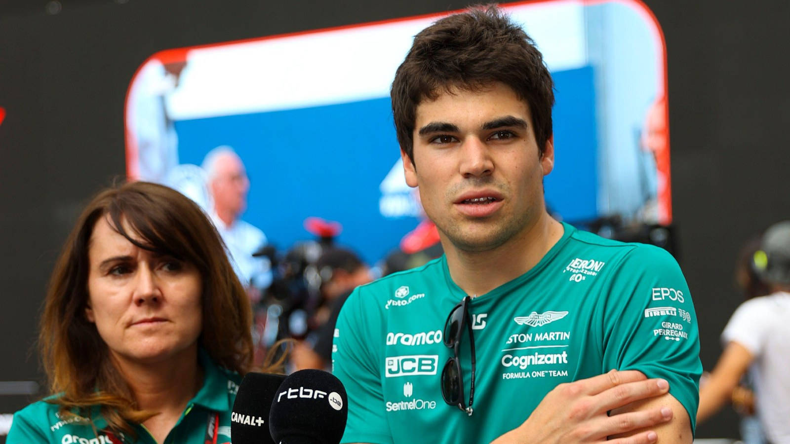 F1 Driver Lance Stroll Engaging In A Candid Interview Background