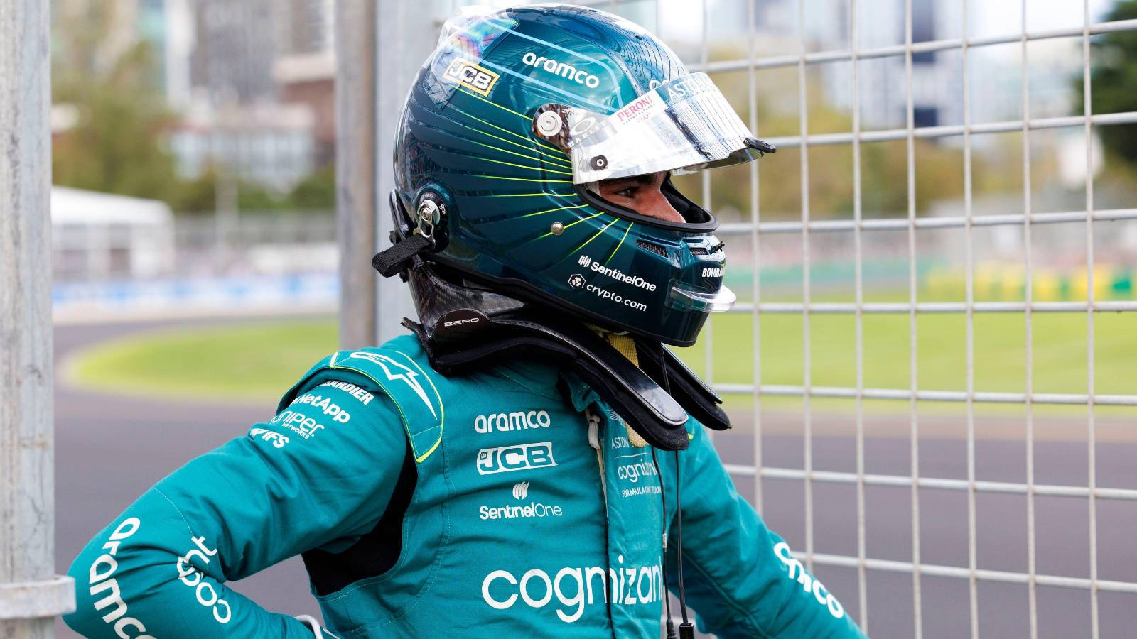 F1 Racer Lance Stroll Intently Studies The Track Background