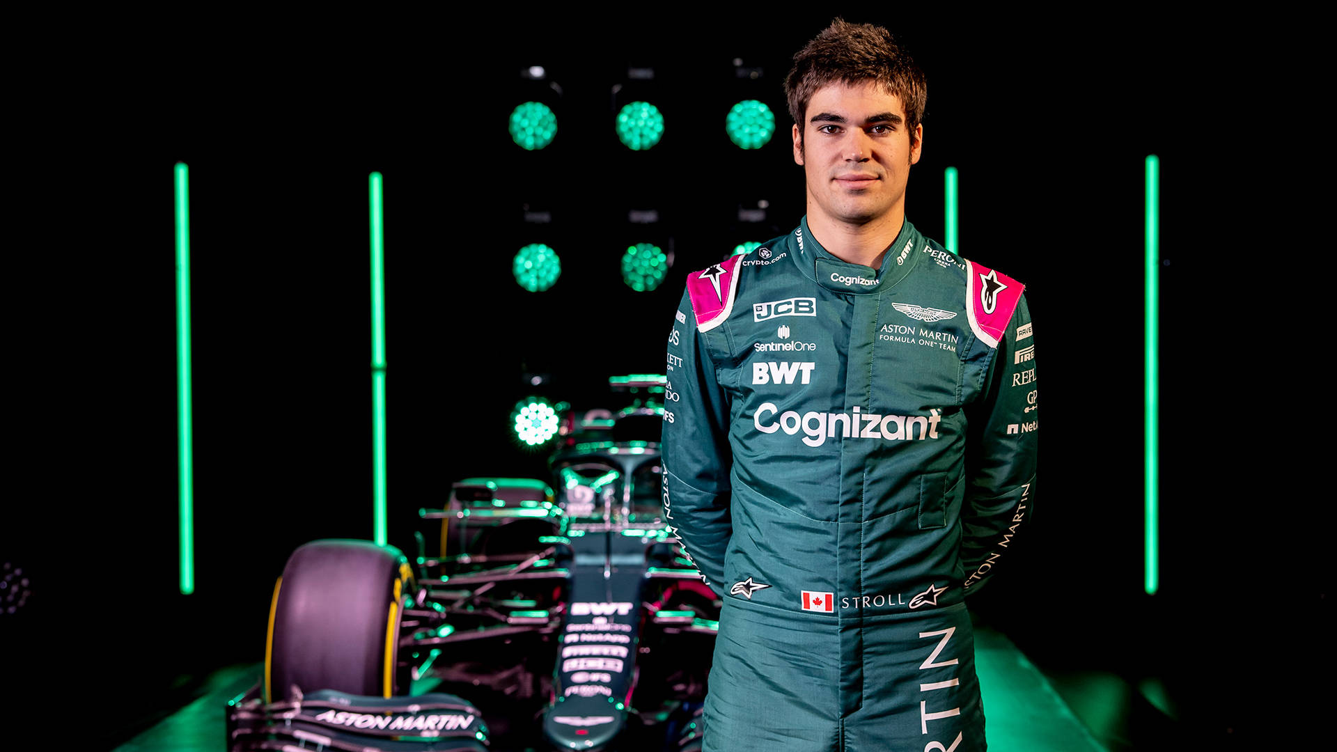 F1 Star Lance Stroll Posing With His Racing Car Background