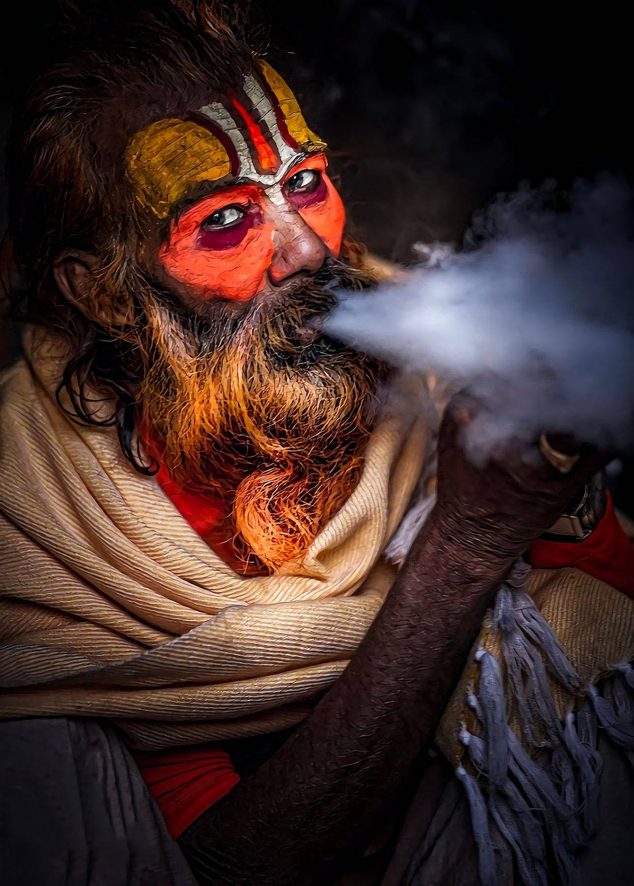 Face Painted Aghori Smoking