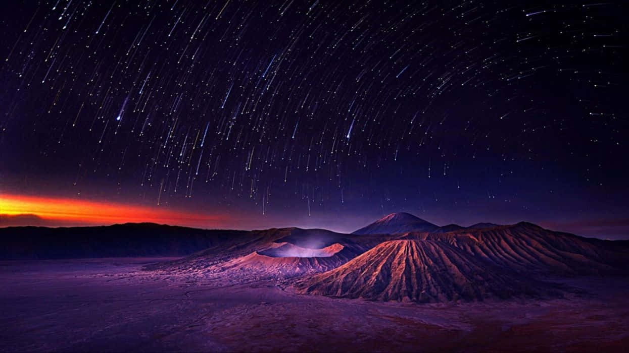 Faint Stars Fill A Dark Night Sky Background