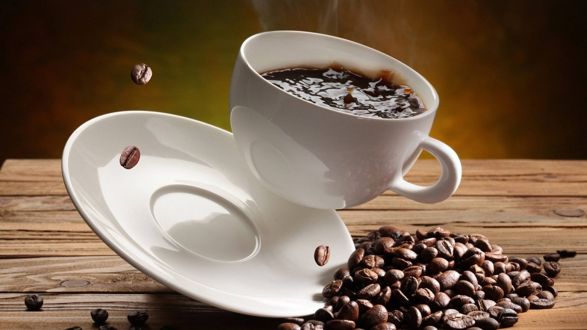 Falling Cup On Coffee Beans Background