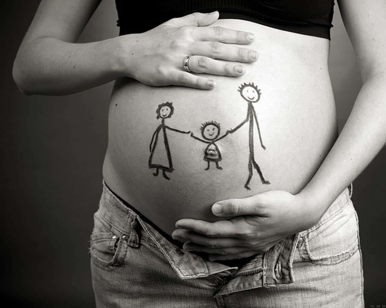 Family Celebrating Pregnancy With Belly Painting Background