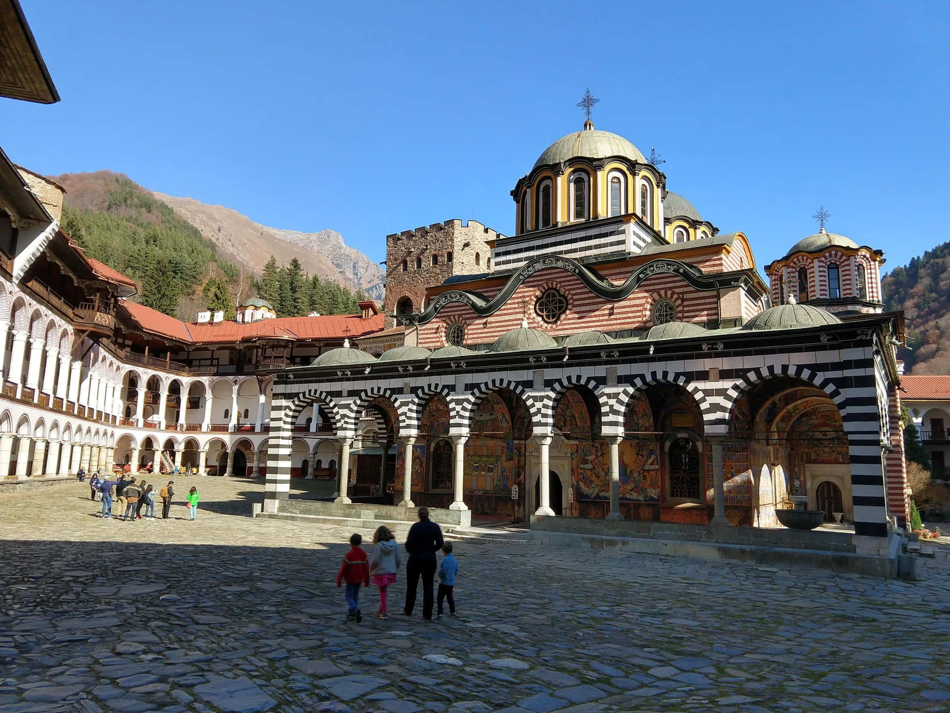 Family Outside The Rila Monastery Background