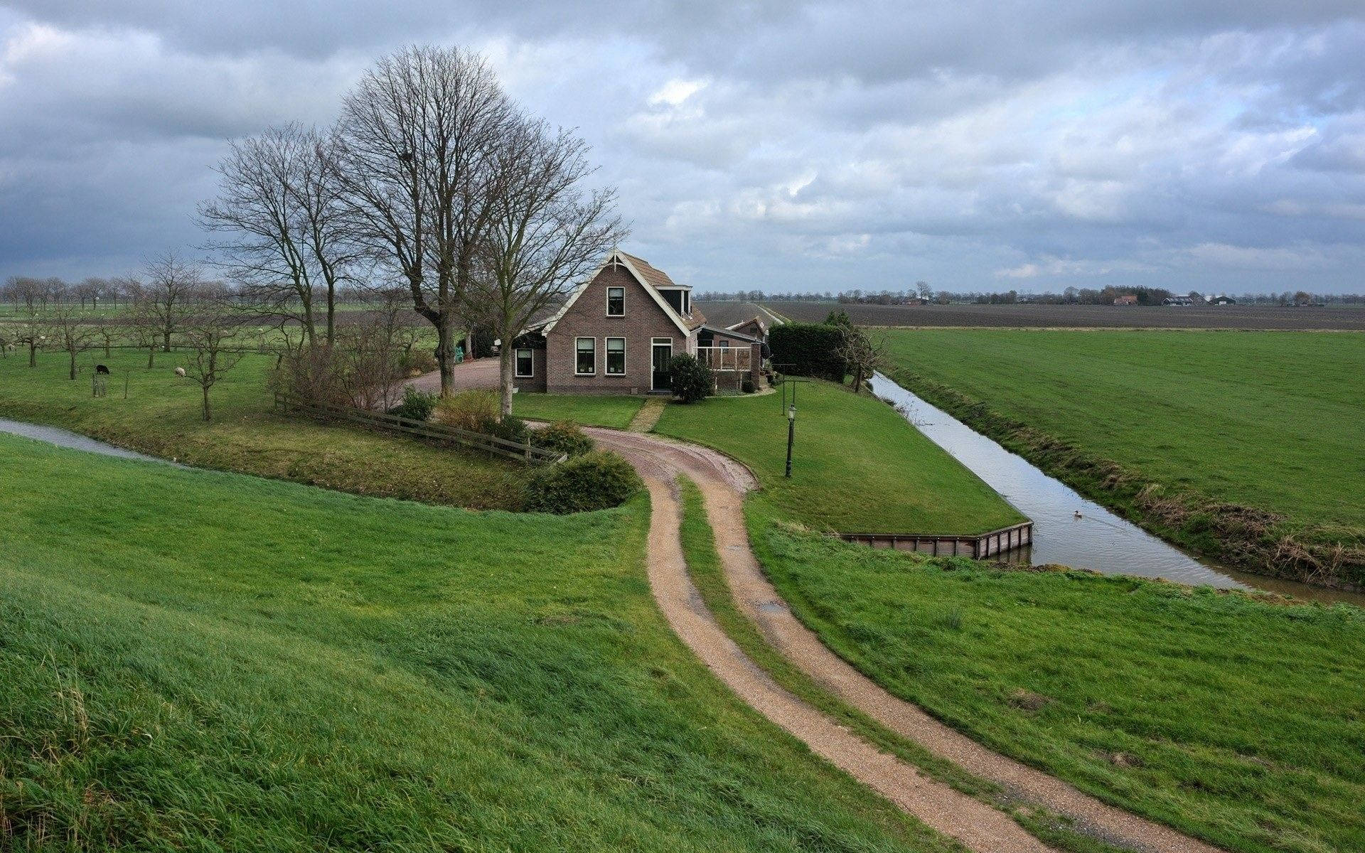 Farmhouse Beside An Irrigation Canal Background