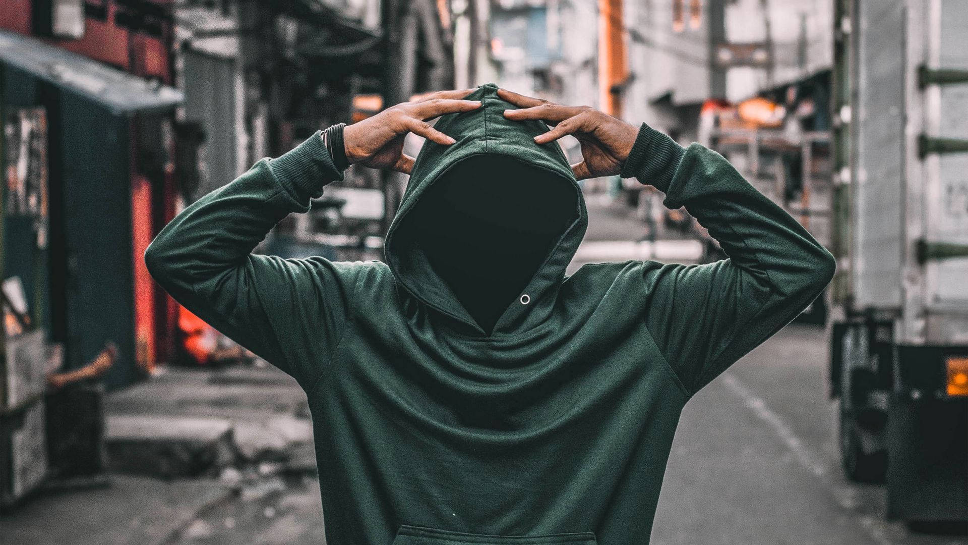 Fashion-forward Green Hoodie On City Streets Background