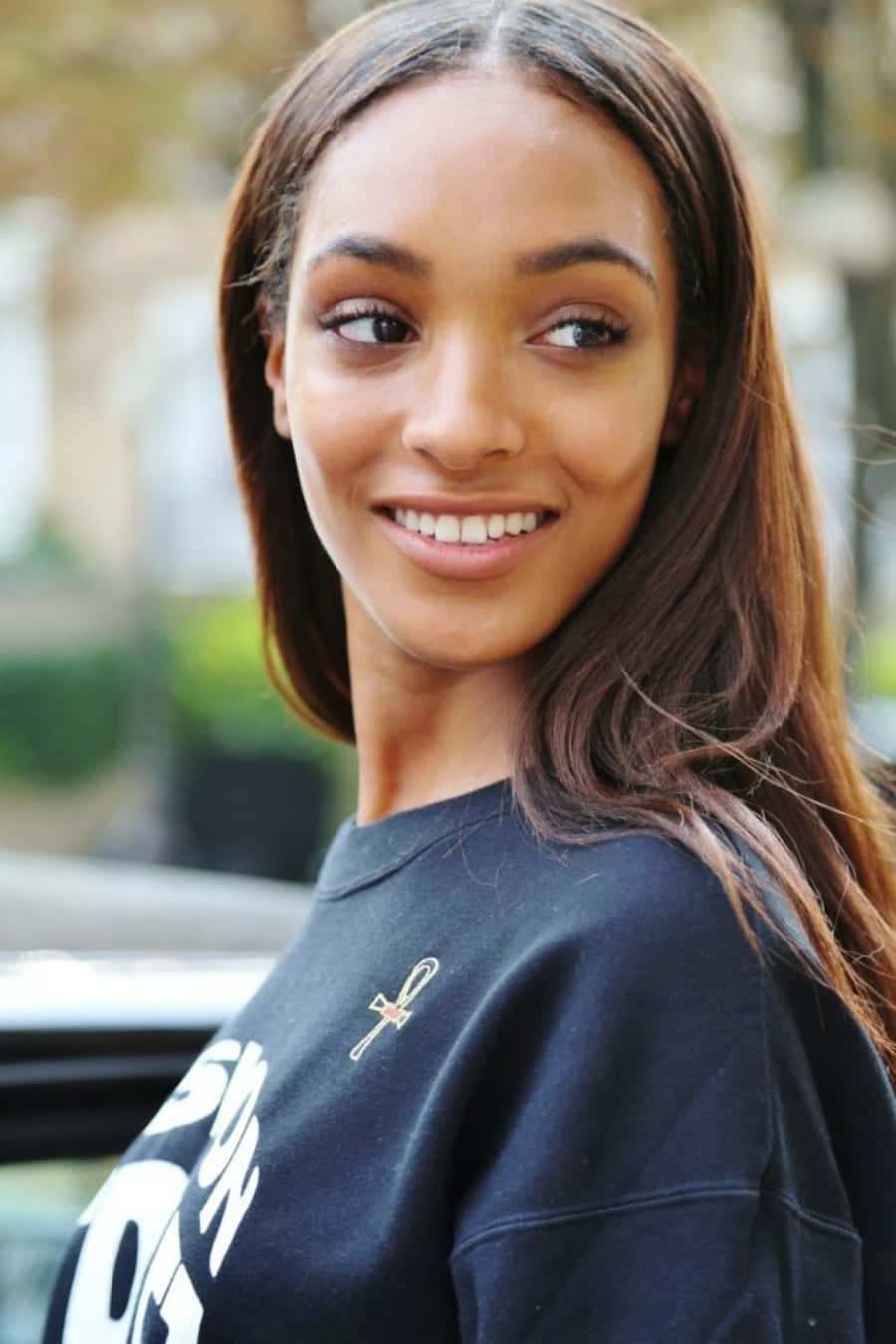 Fashionable Jourdan Dunn Posing With A Confident Smile. Background