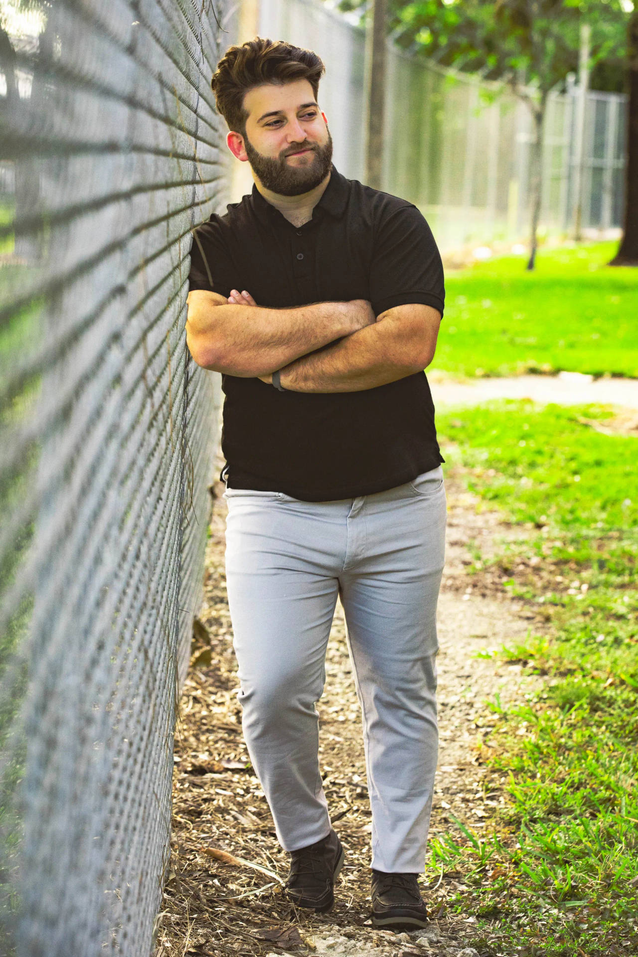 Fat Person Posing By Fence Background