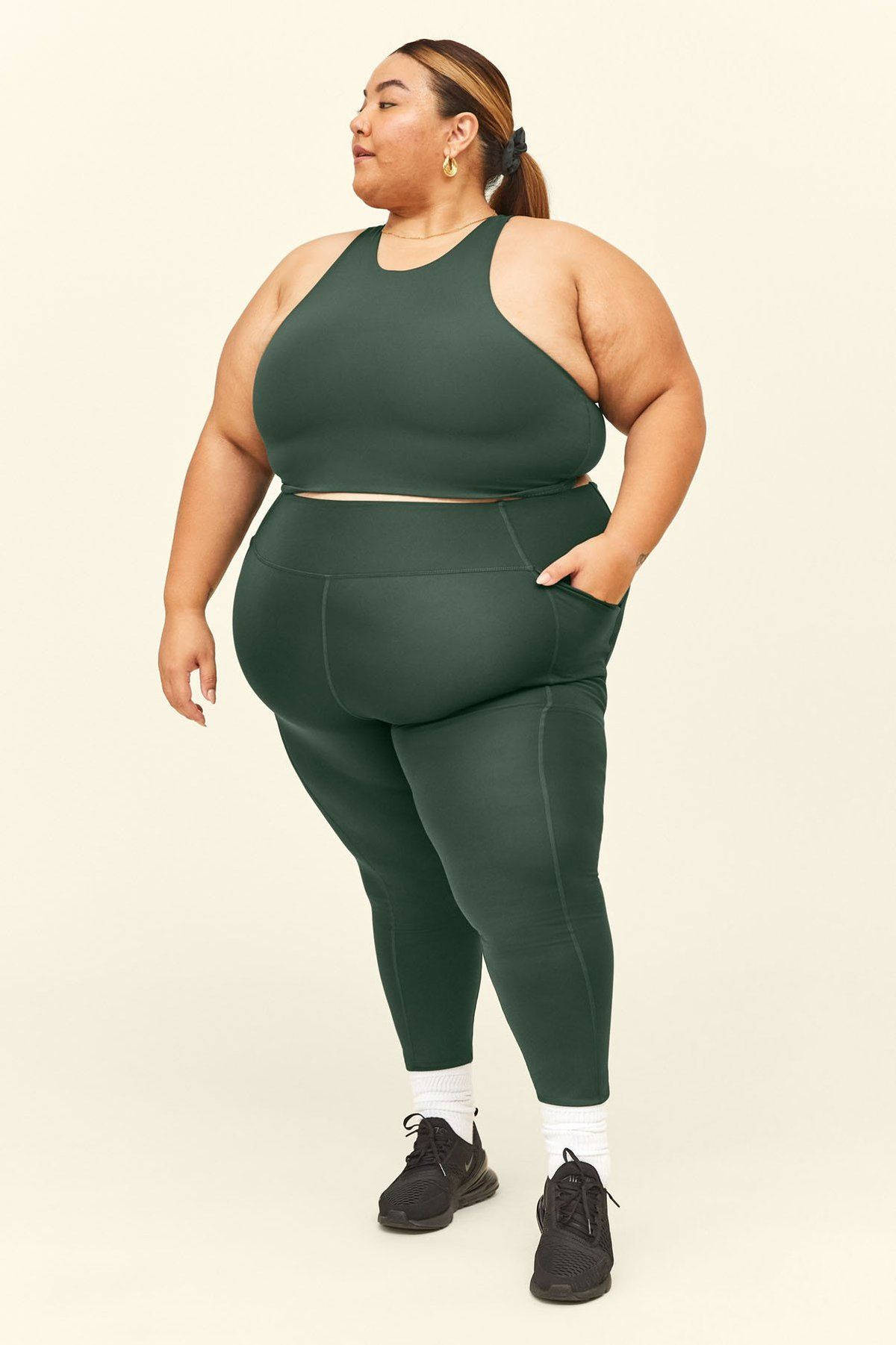 Fat Woman In Green Workout Clothes Background