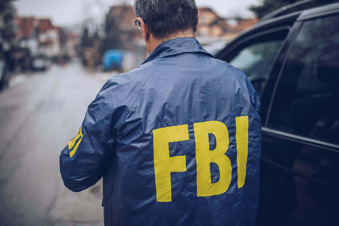 Fbi Agent Standing Next To A Car Background