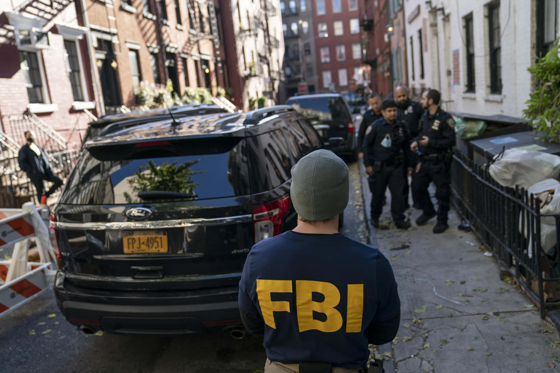 Fbi Agents Stand In Front Of A Car Background