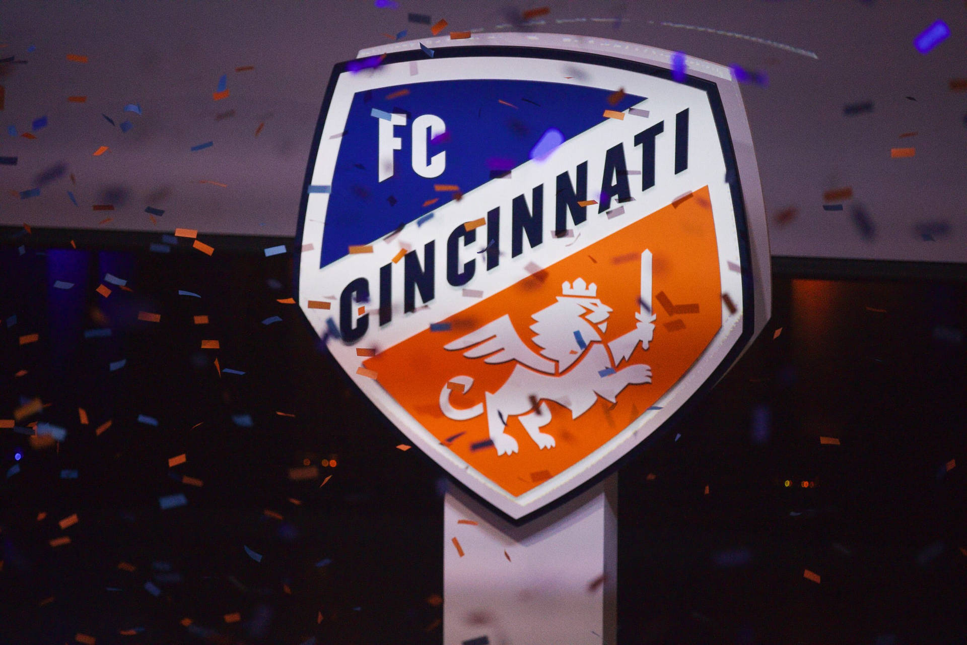 Fc Cincinnati Logo Surrounded By A Confetti Background