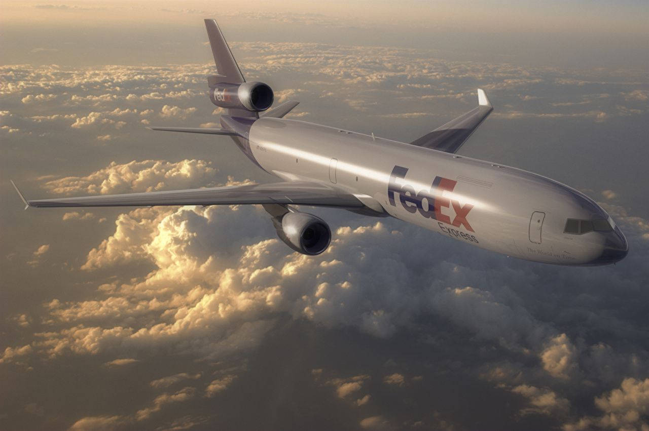 Fedex Passenger Plane Above Clouds Background