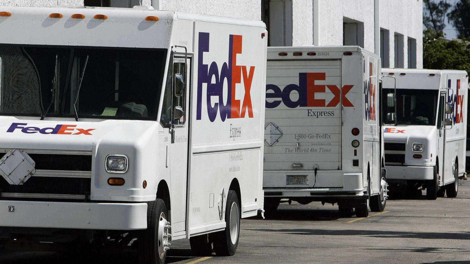 Fedex Tracking Vehicles Parked Background