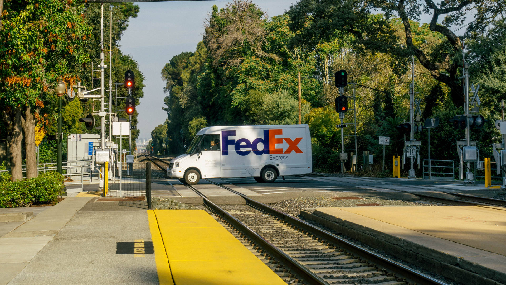 Fedex Van At Railway Crossing Background
