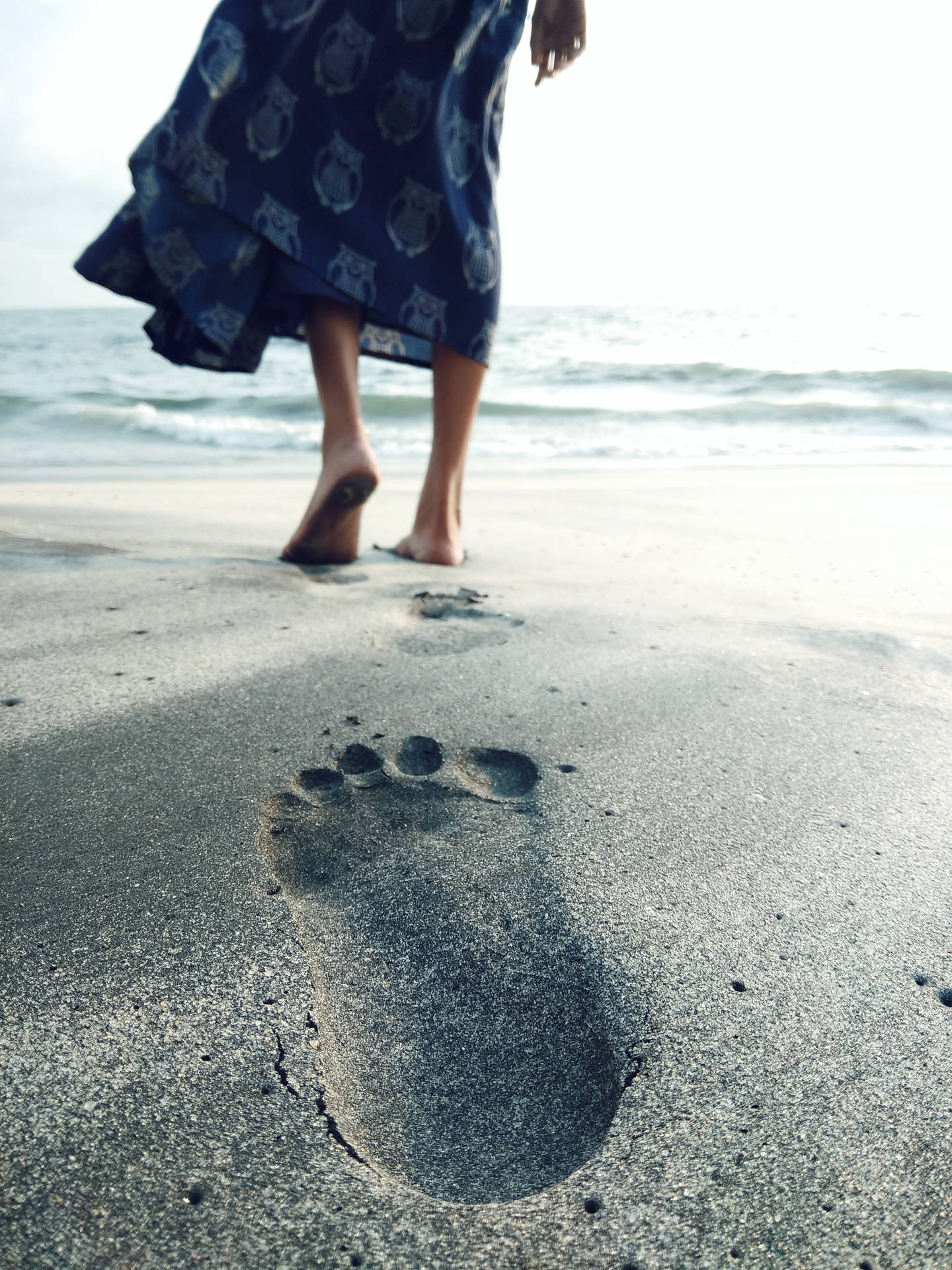 Feet And Footprints On The Sand Background