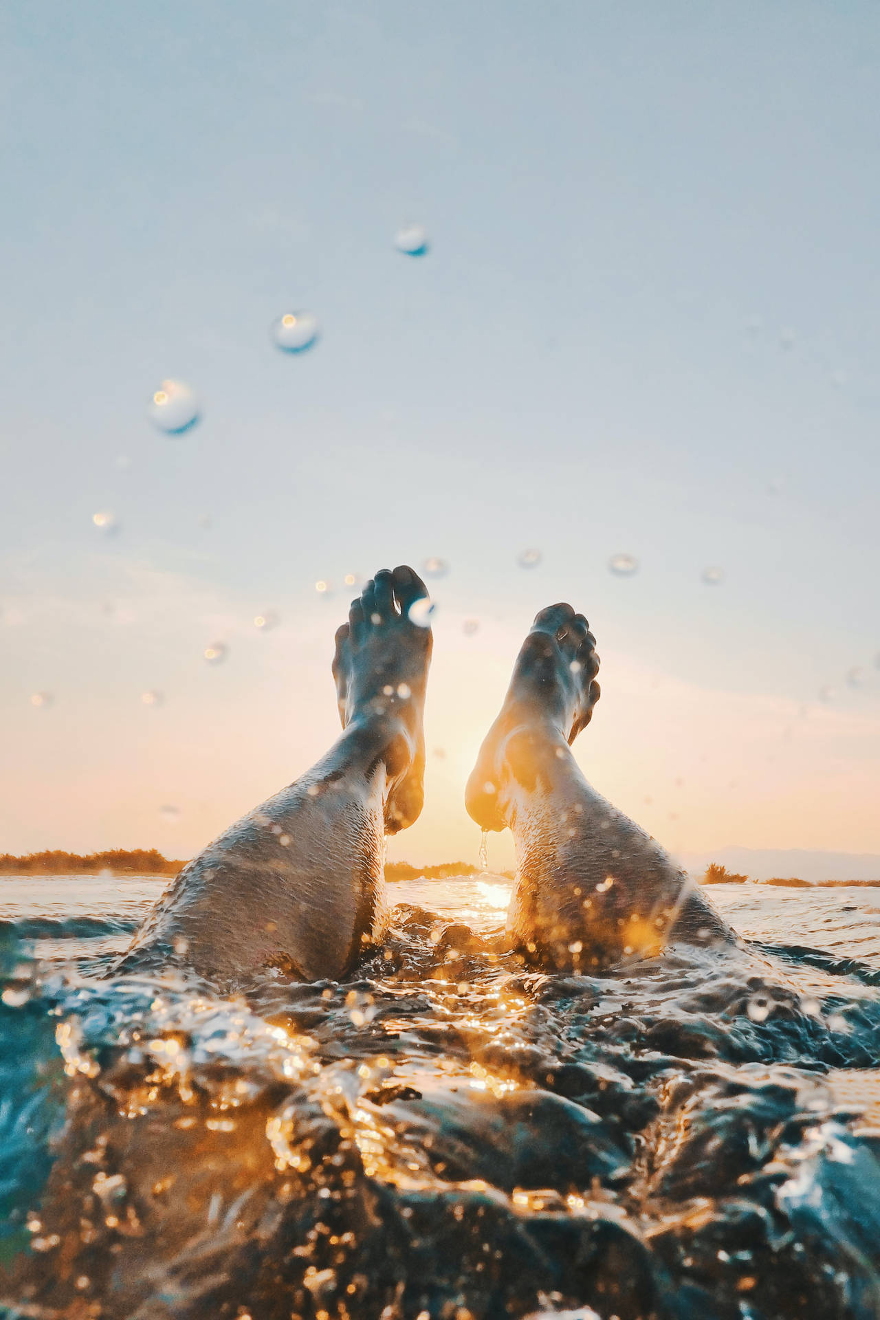 Feet Floating On The Vast Ocean Background