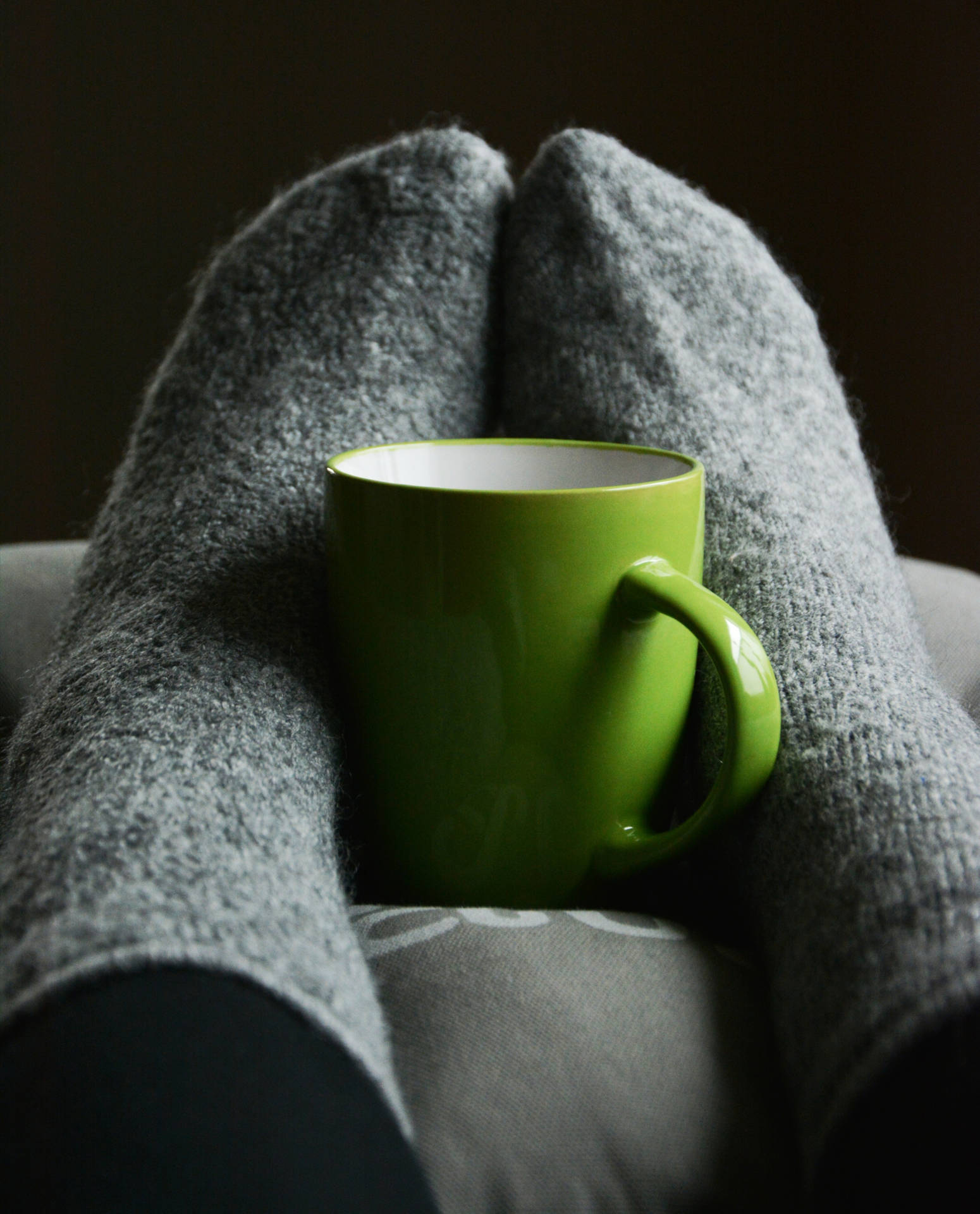 Feet In Cozy Grey Socks Background