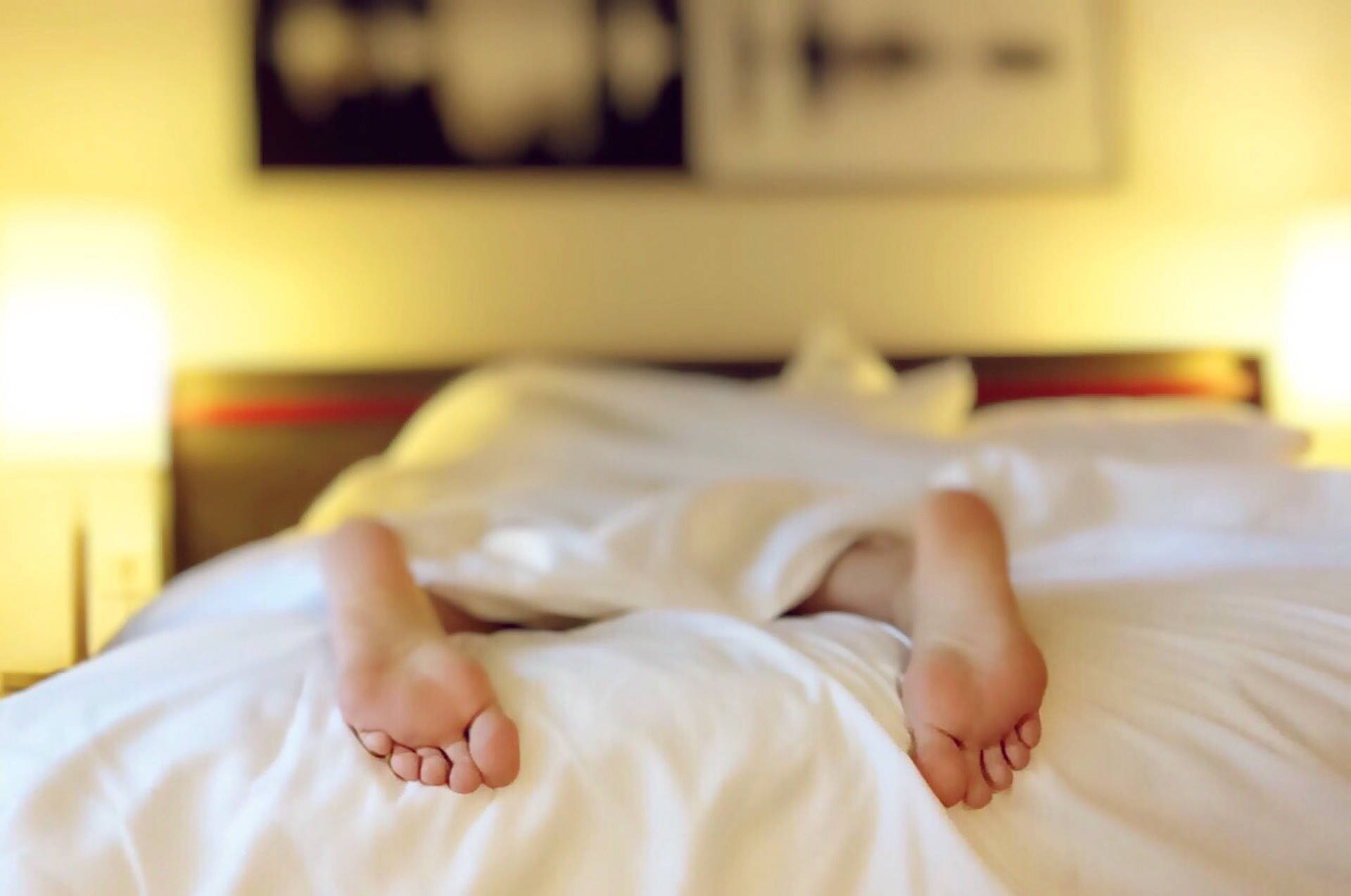 Feet On A White Bed Background