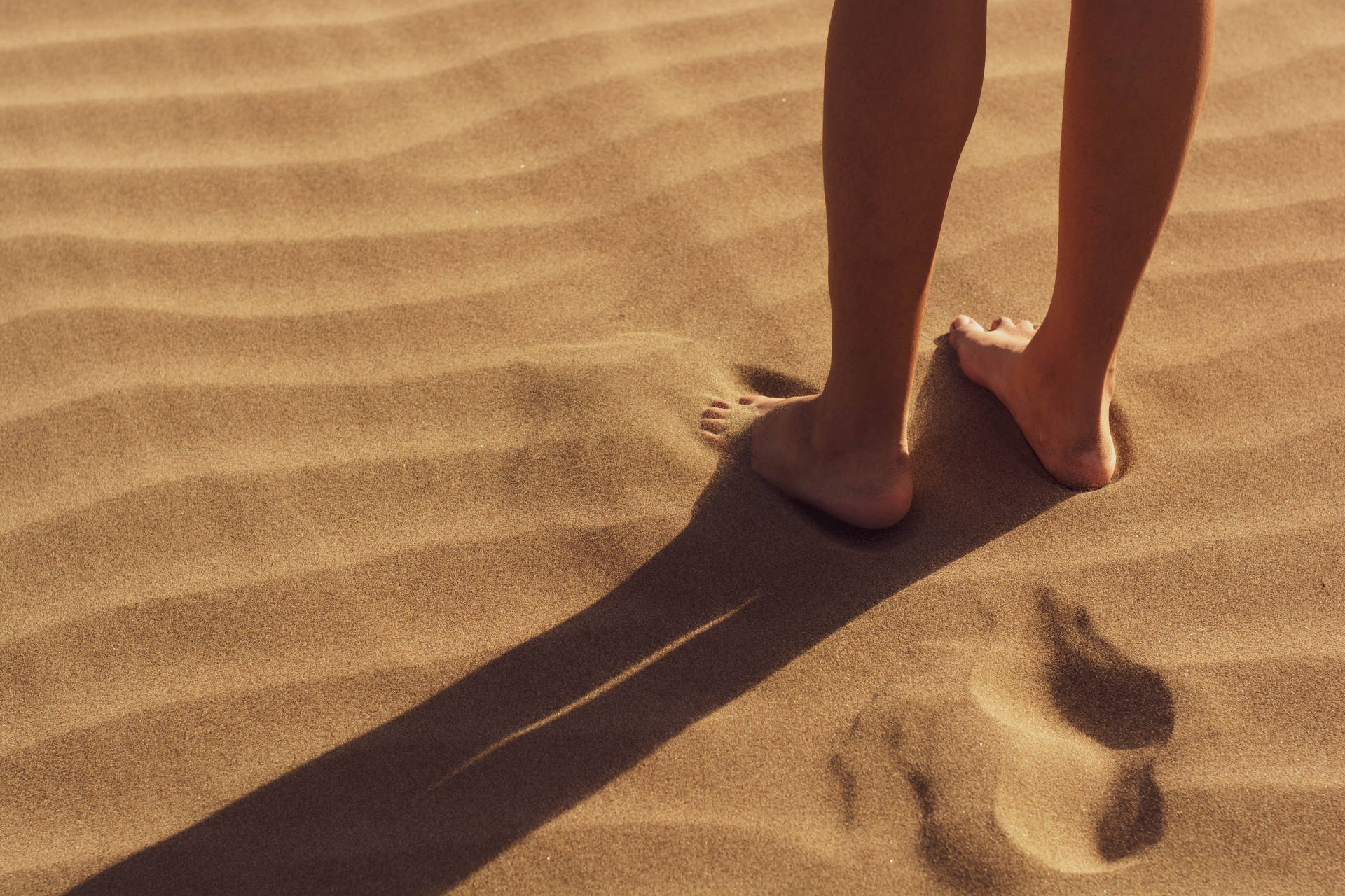 Feet On Fine Sand Dunes Background