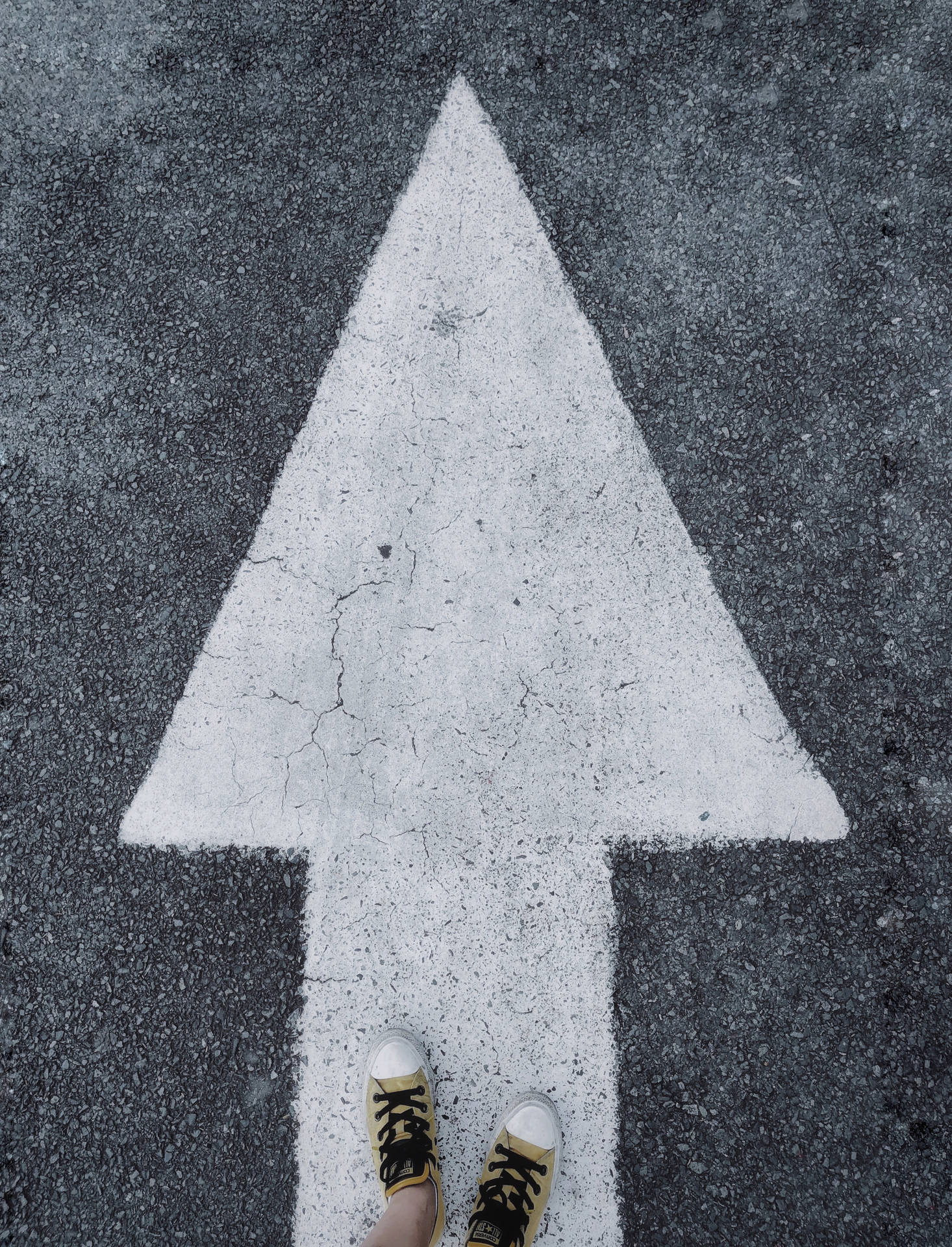 Feet Standing On A White Arrow Background