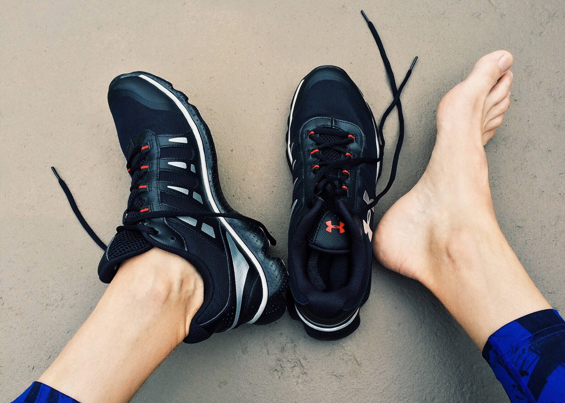 Feet Wearing Black Running Shoes Background