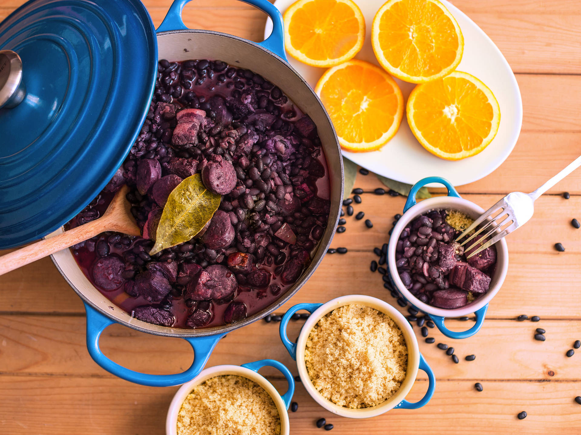 Feijoada - Traditional Brazilian Black Bean Stew Served In A Blue Casserole Background