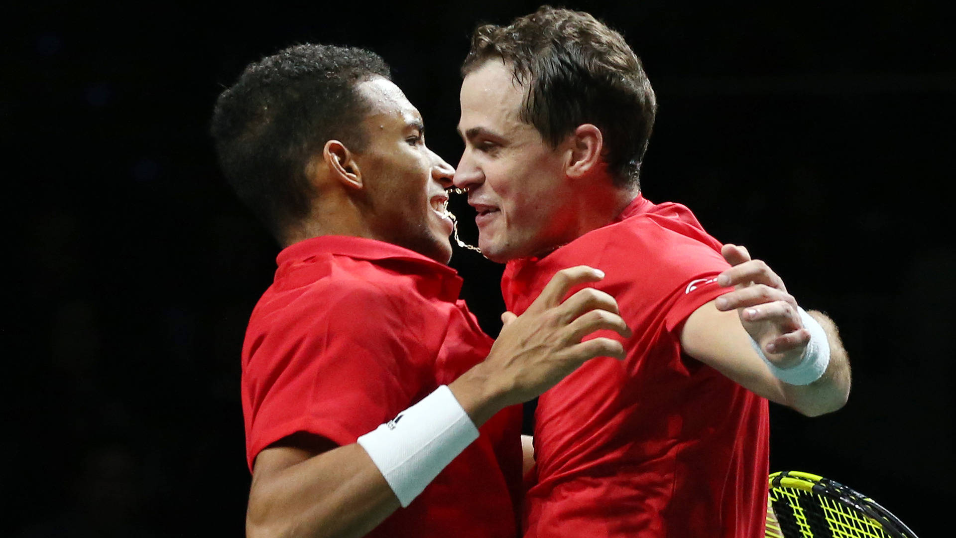 Felix Auger-aliassime Celebrating A Victorious Moment On The Tennis Court With A Jubilant Chest Bump. Background