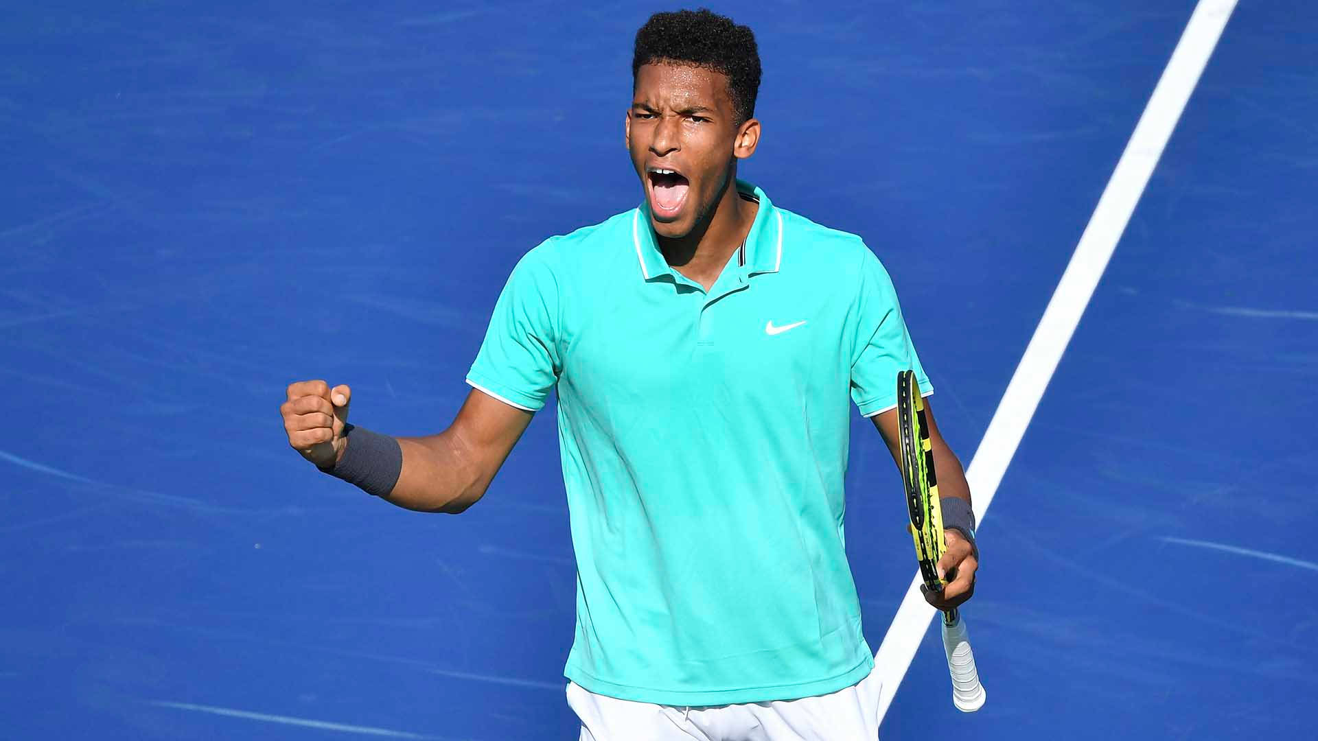 Felix Auger Aliassime Celebratory Fist Pump Background