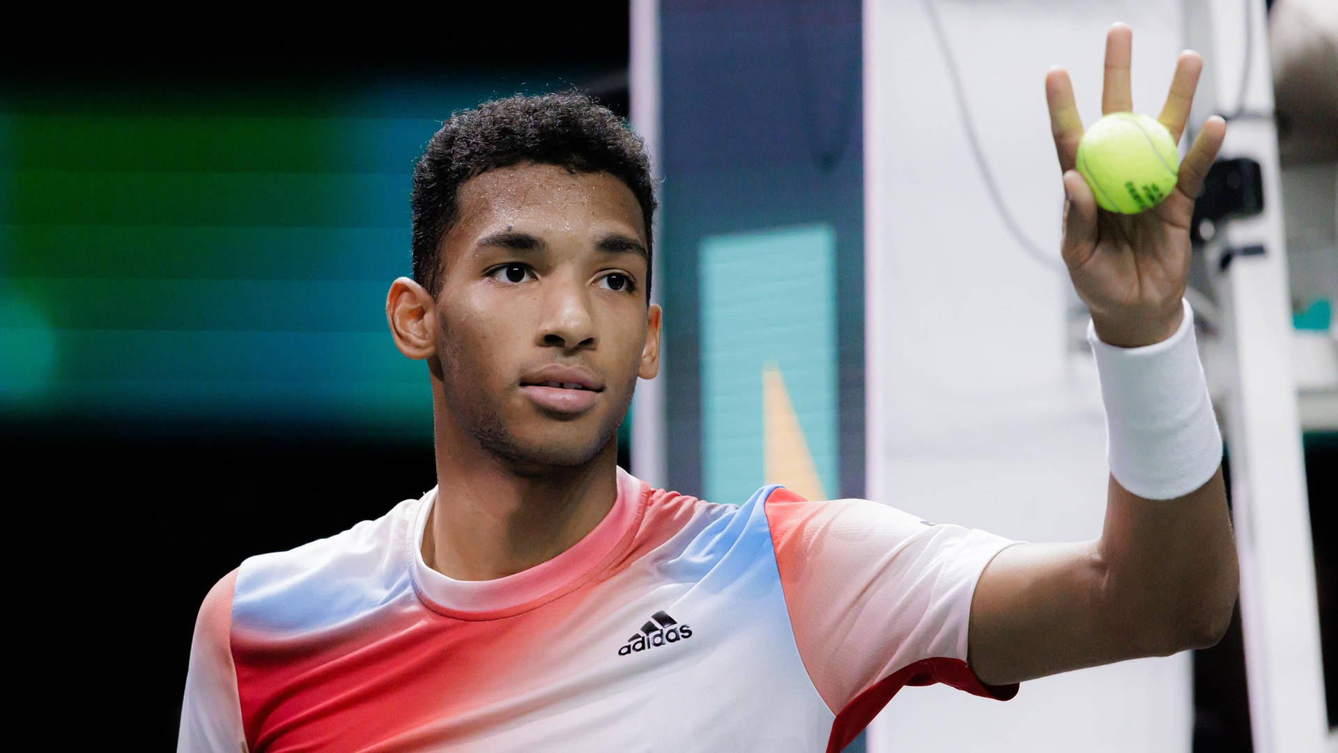 Felix Auger-aliassime Concentrating On The Ball Background