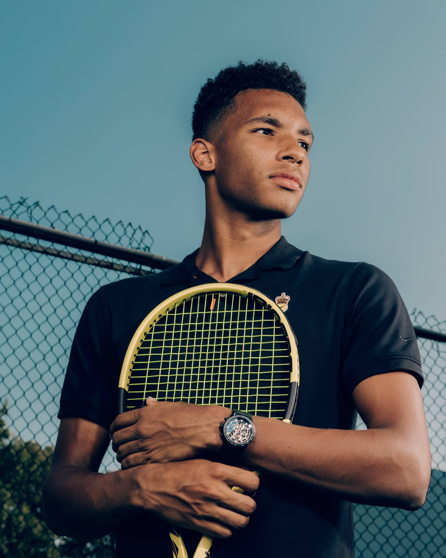 Felix Auger Aliassime In An Intense Moment, Embracing His Racket On Court. Background