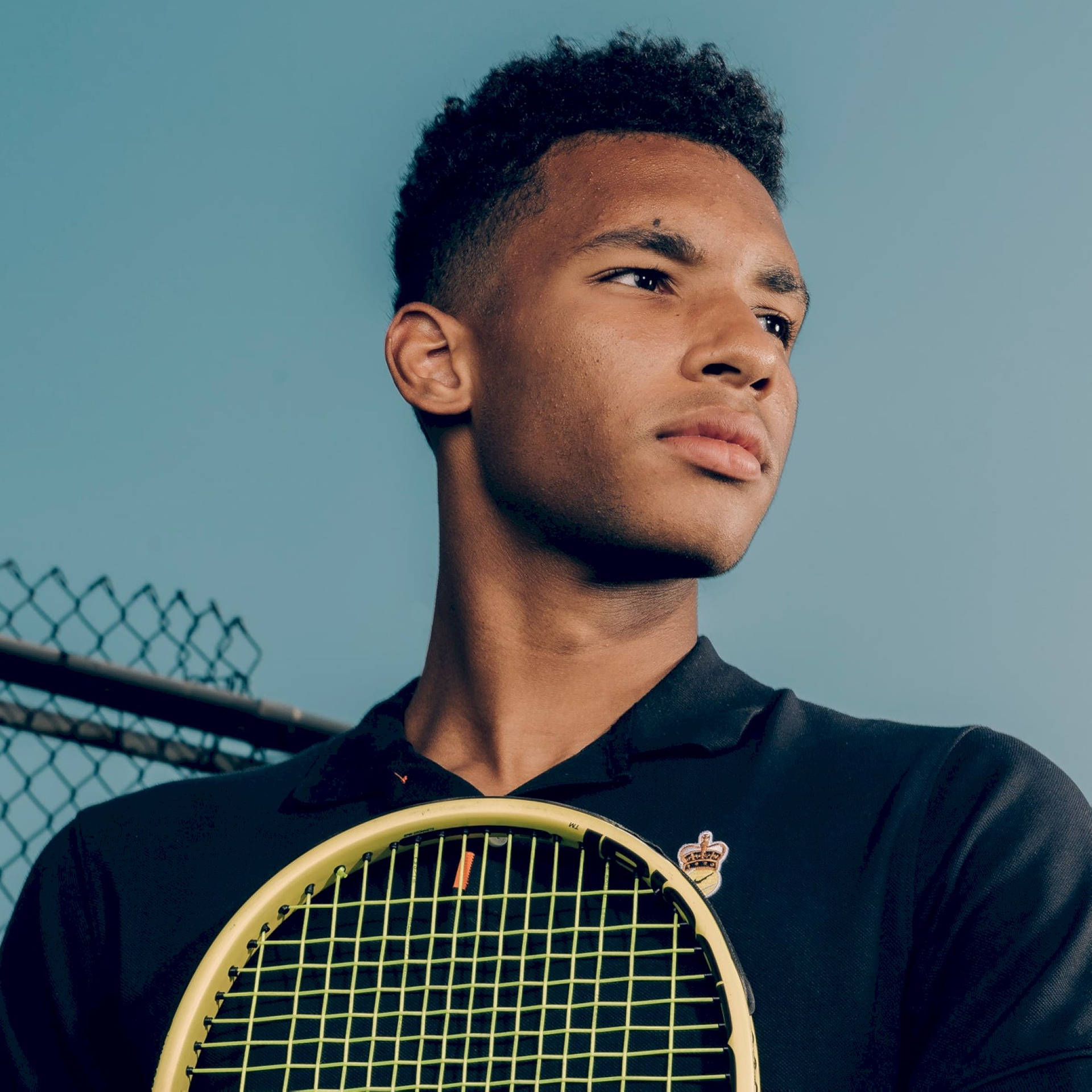 Felix Auger-aliassime In Thoughtful Contemplation Background