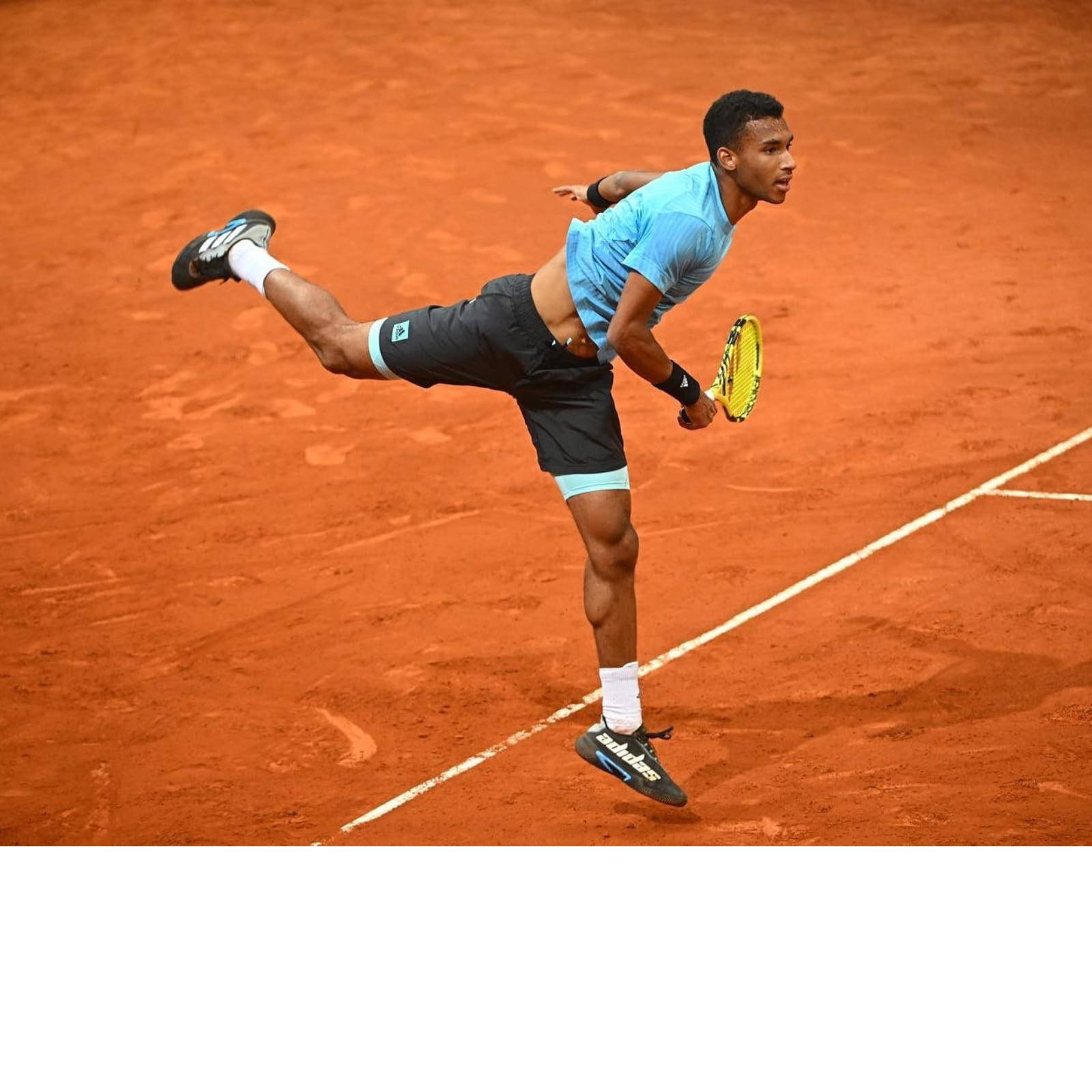 Felix Auger-aliassime Playing On Clay Court Background