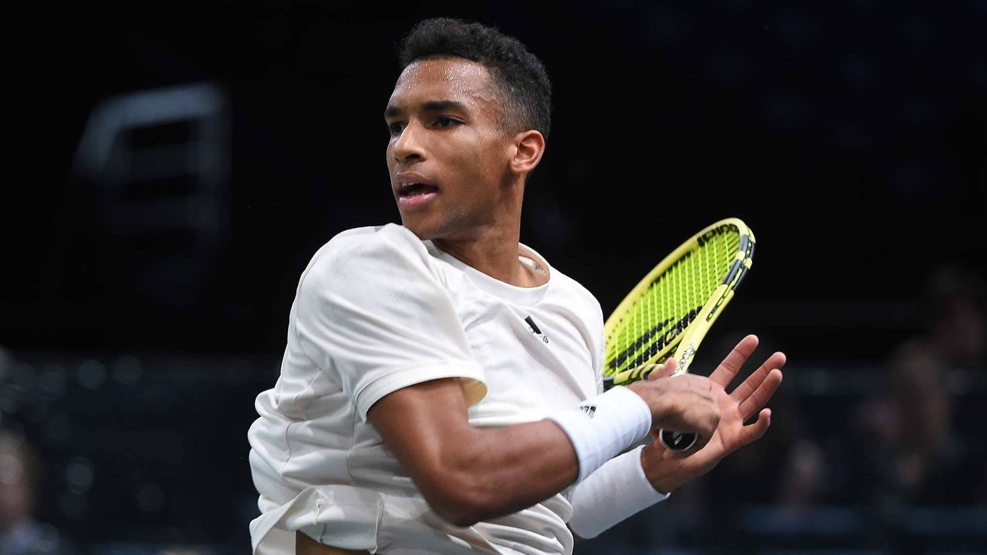 Felix Auger Aliassime Swinging Background