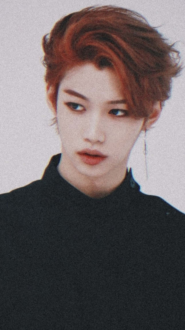 Felix From Stray Kids Looking Goofy And Dapper In Pink Background