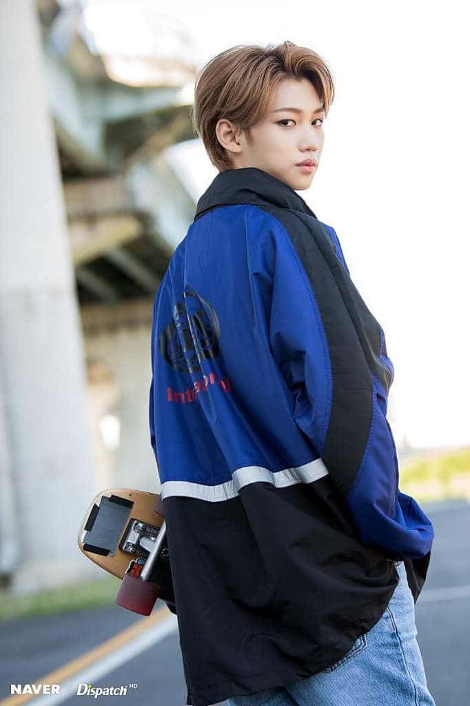 Felix Of Stray Kids Smiles Confidently. Background