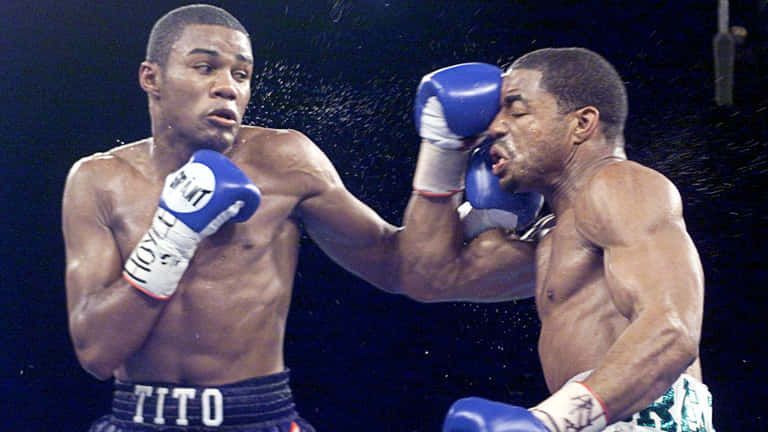 Felix Trinidad Striking The Opposing Player Background