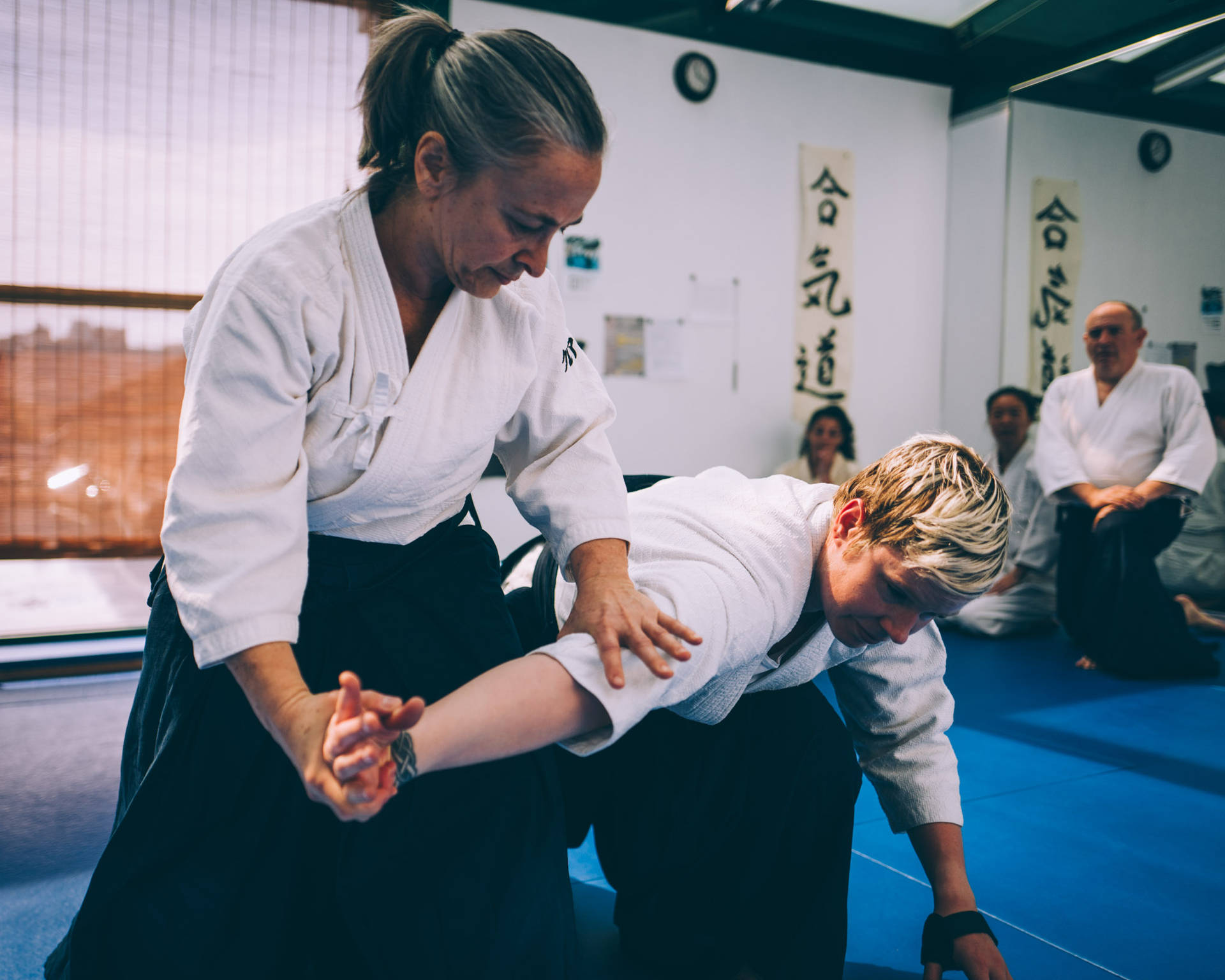 Female Aikidoka Performing Nikyo Aikido Technique Background