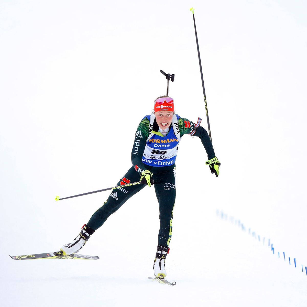 Female Biathlon Athlete Skiing Downhill Background