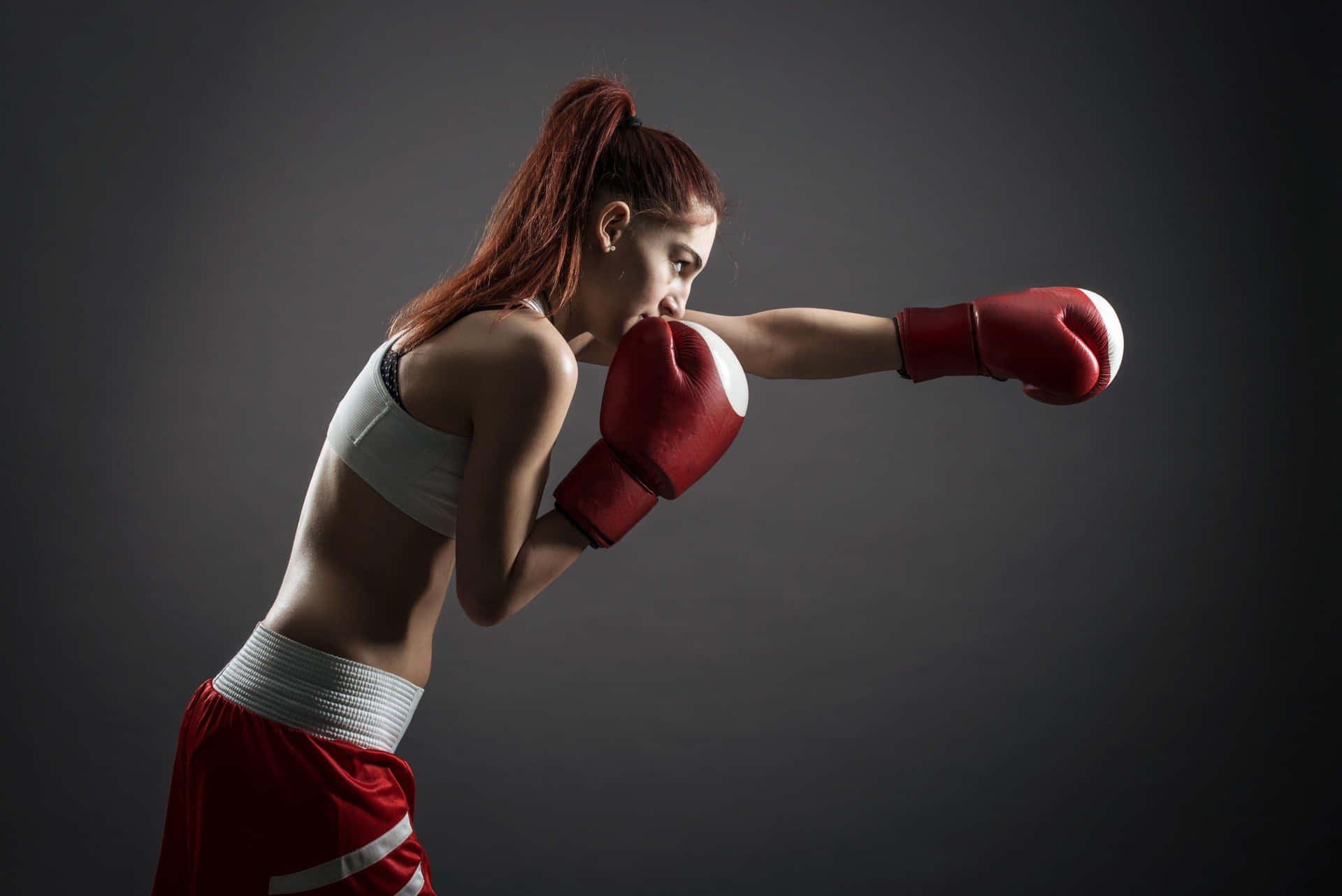 Female Boxer Throwing Punch Background