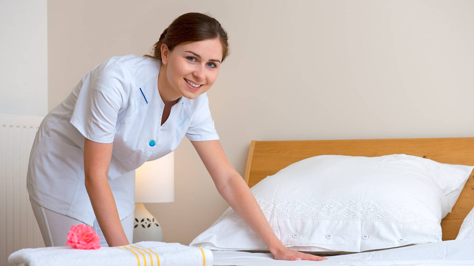 Female Housekeeper Smile Cleaning Bed Background