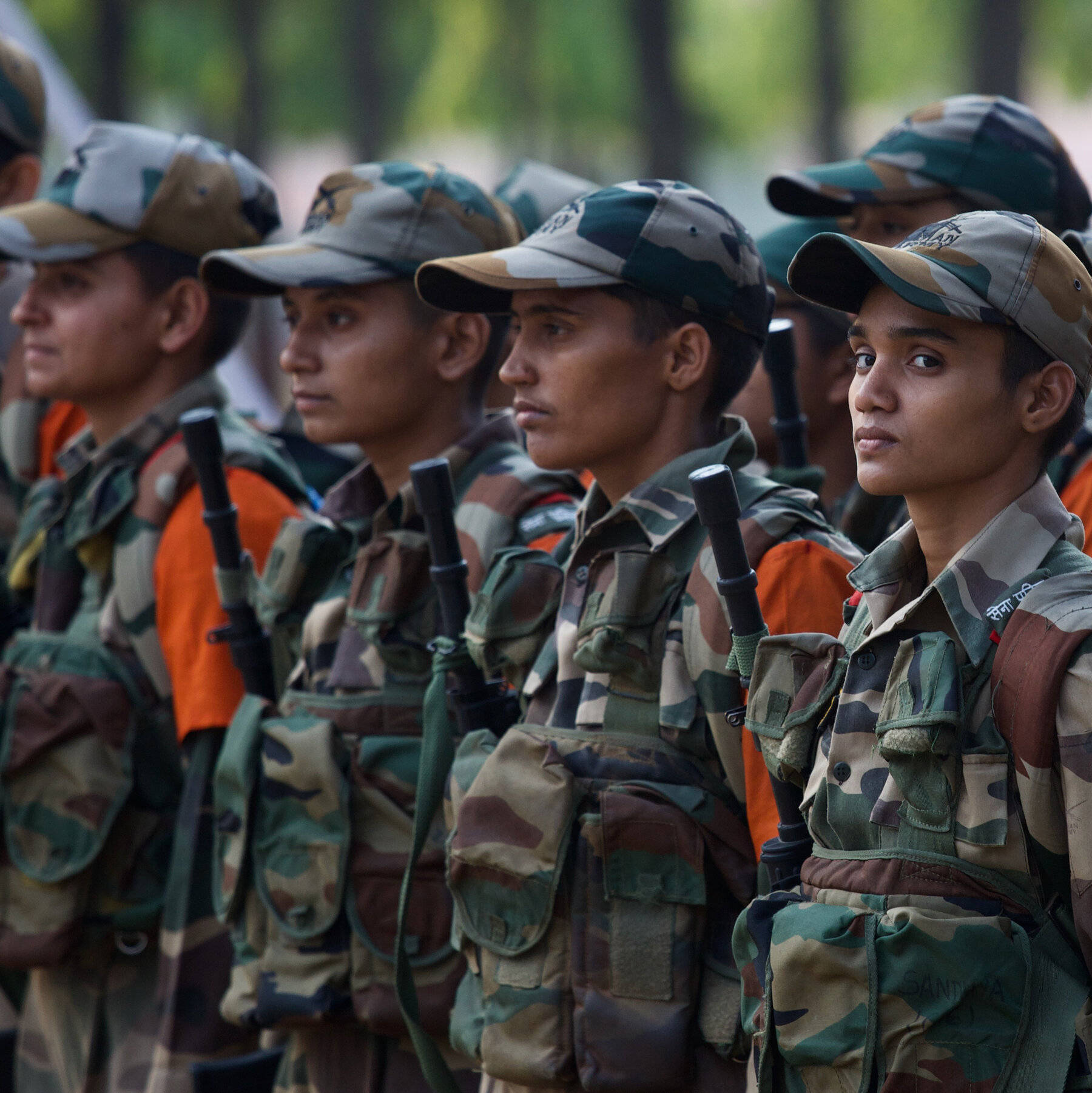 Female Indian Soldiers Standing At Attention Background
