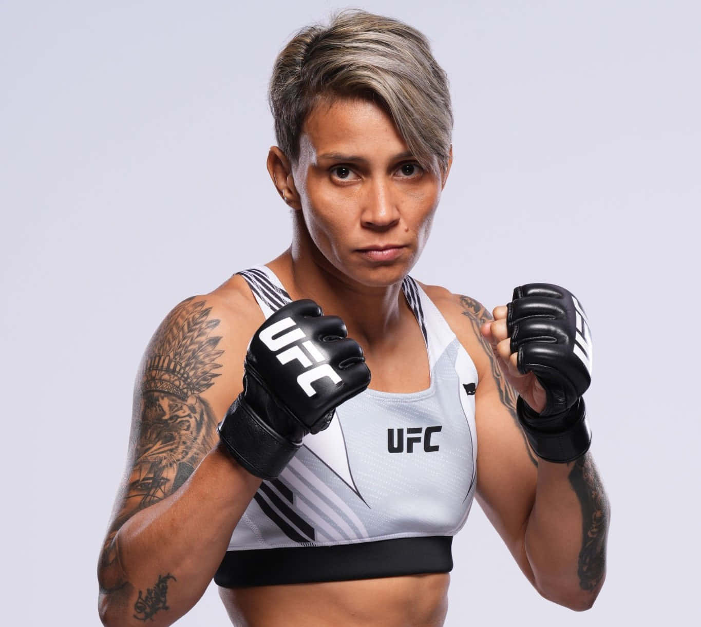 Female M M A Fighter Readyfor Combat Background