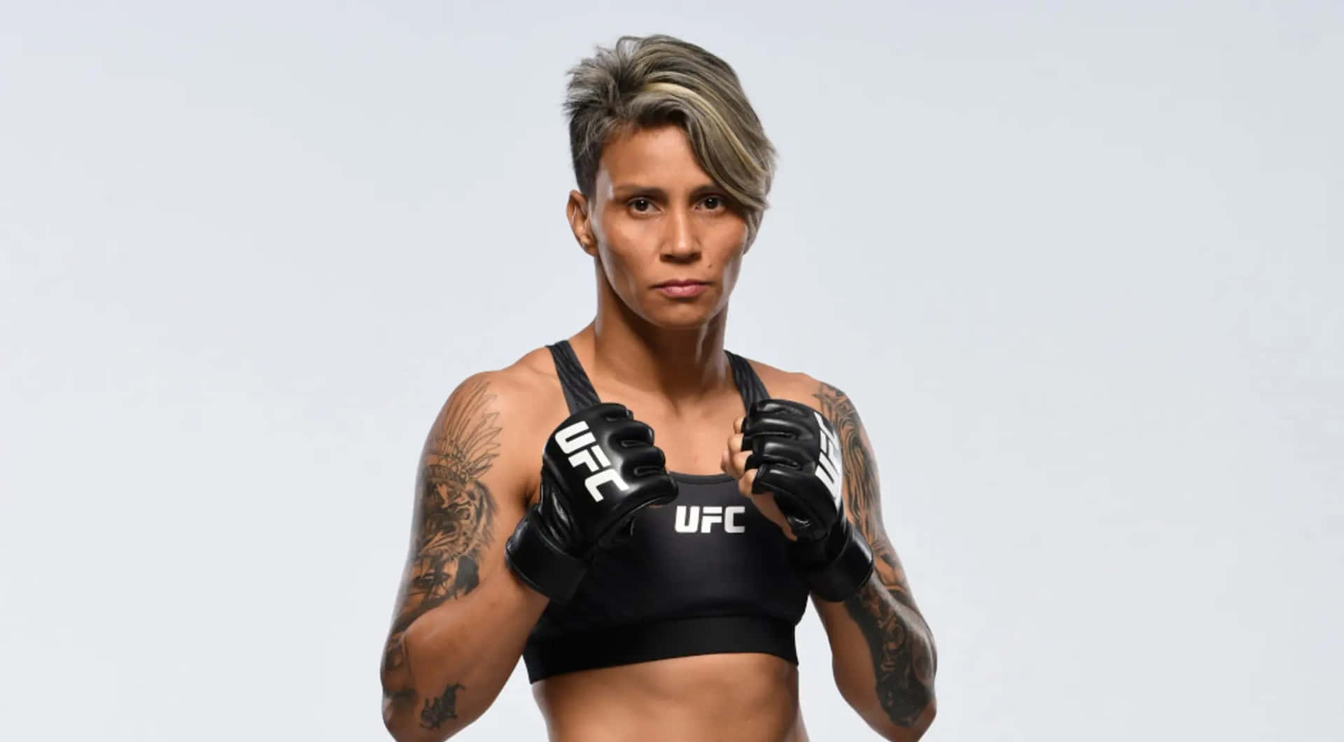 Female M M A Fighter Readyfor Combat Background