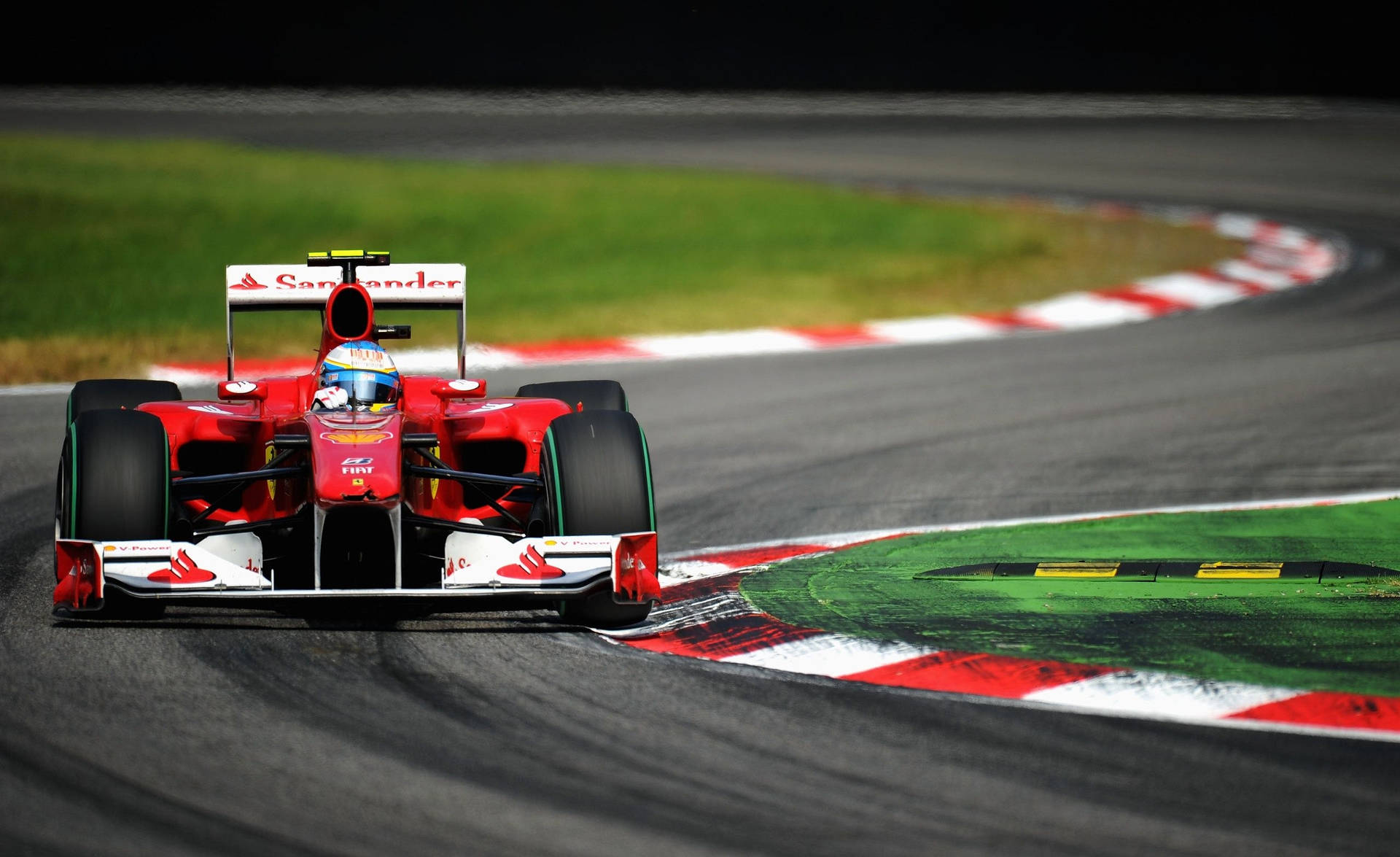 Ferrari F1 Car Driving Down A Track Background