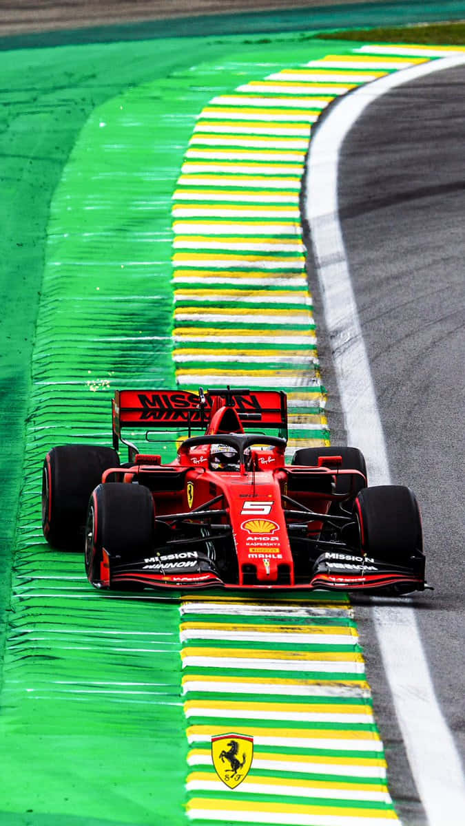 Ferrari F1 Car Driving Down A Track Background