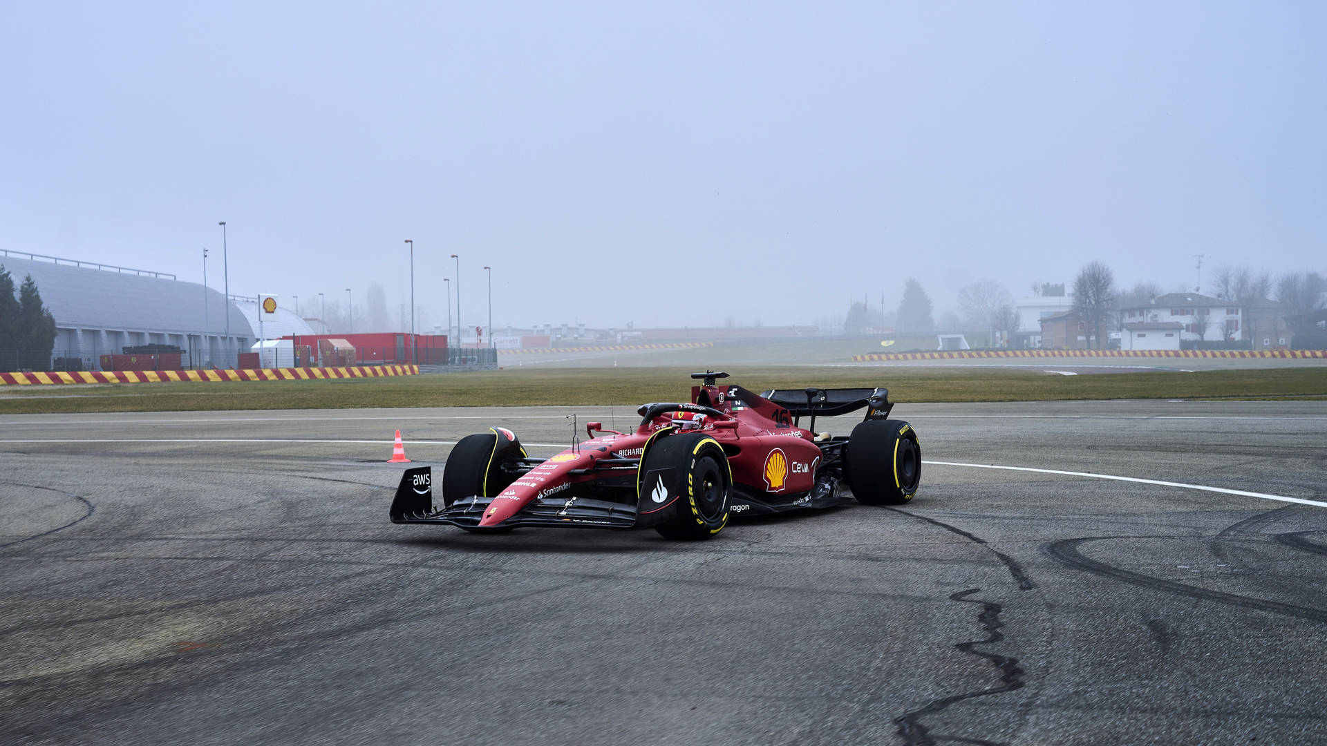 Ferrari F1 Car Driving On A Track In The Fog Background