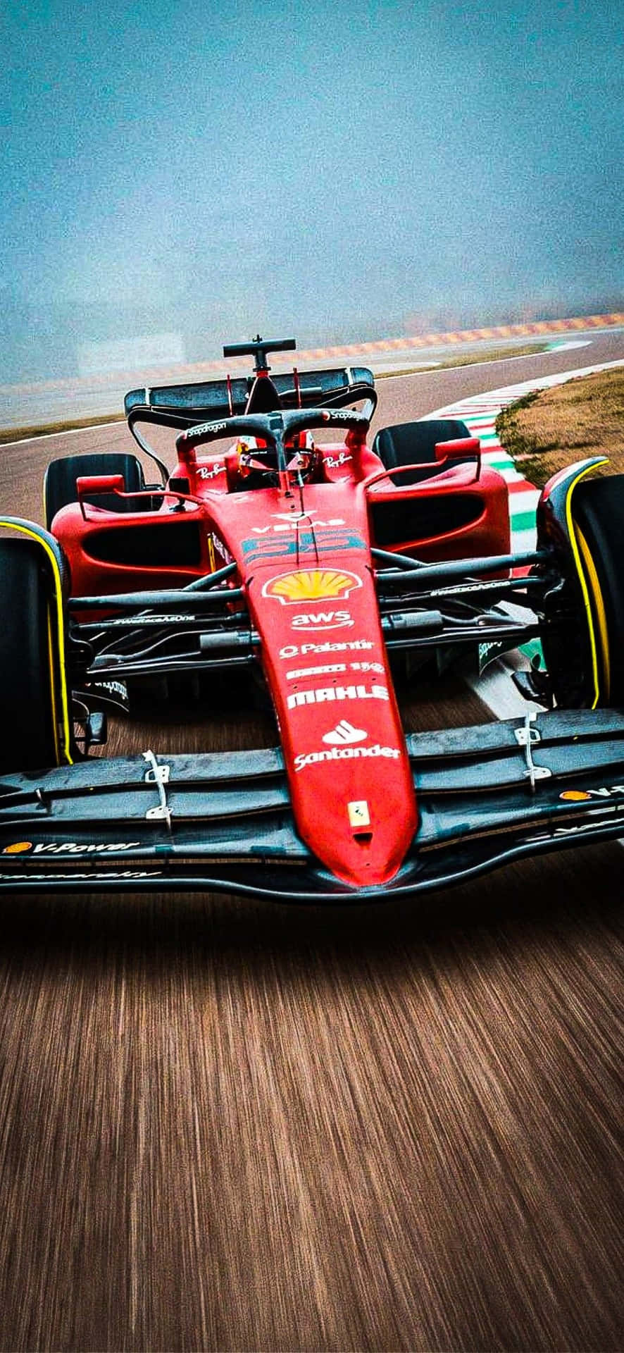 Ferrari F1 Car Driving On A Track Background