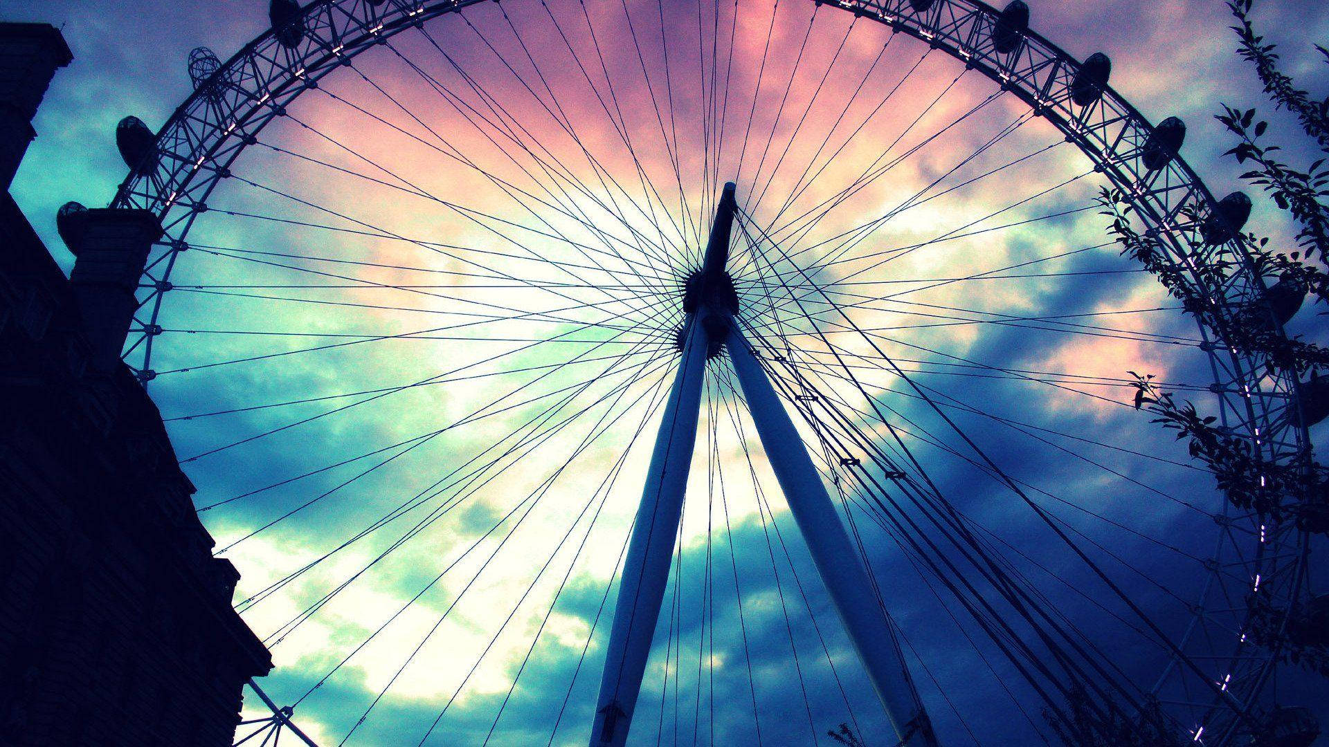 Ferris Wheel Under Colorful Sky Background