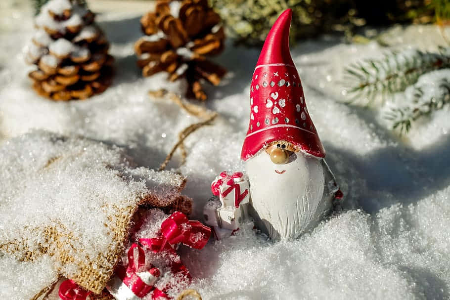 Festive Christmas Gnome Sitting On A Snowy Window Sill Background